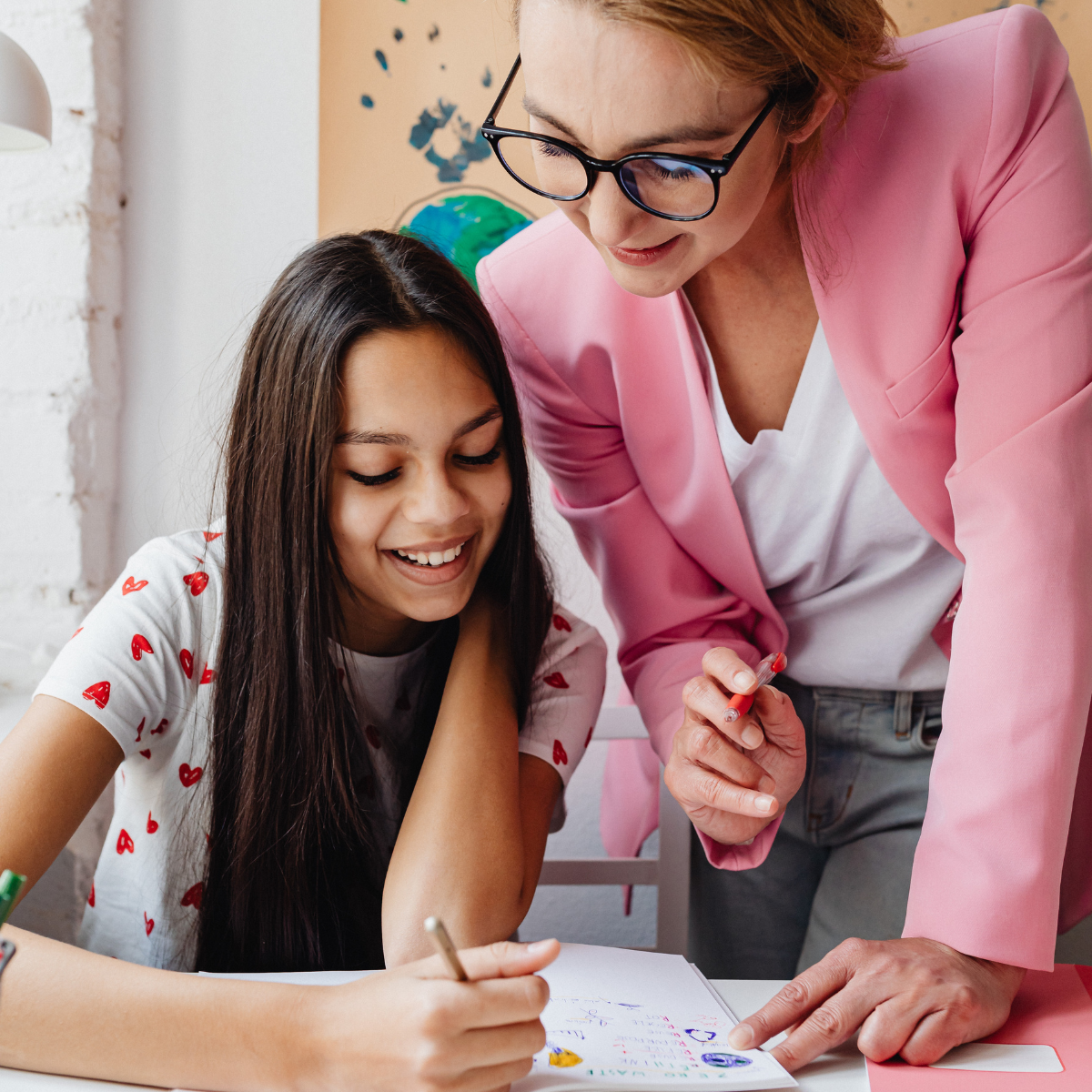 student and teacher work together on an assignment